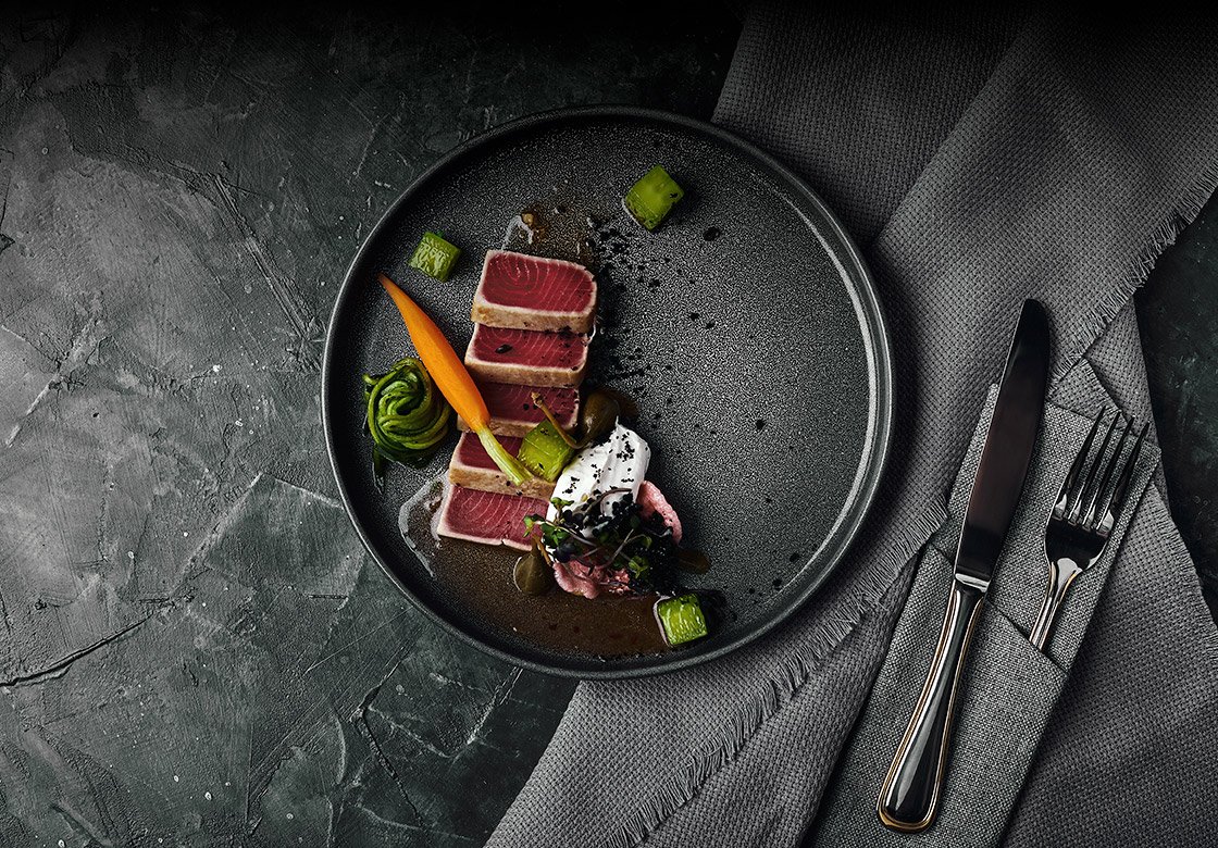 seared tuna dish fine dining plating with vegetables in a coastal restaurant style