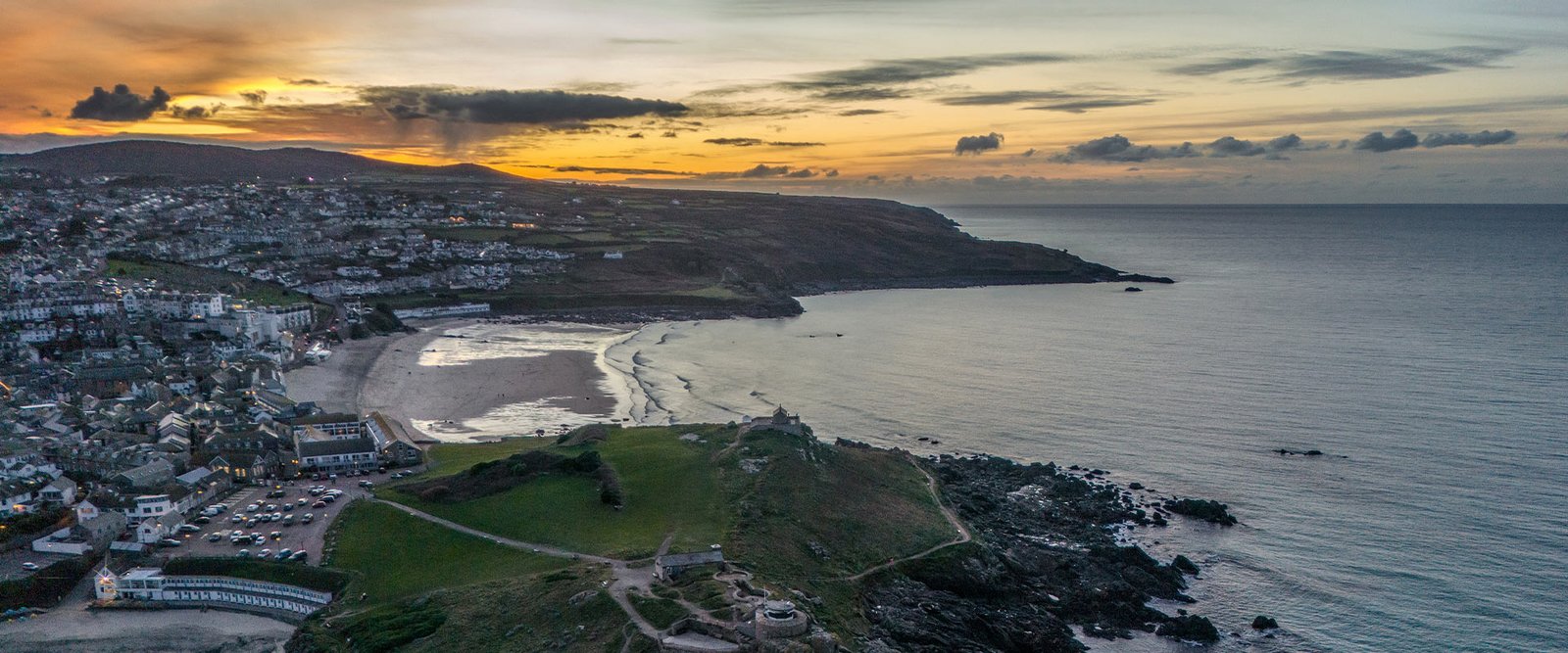 Cornwall coastline at sunset with rocky shore and Atlantic sea