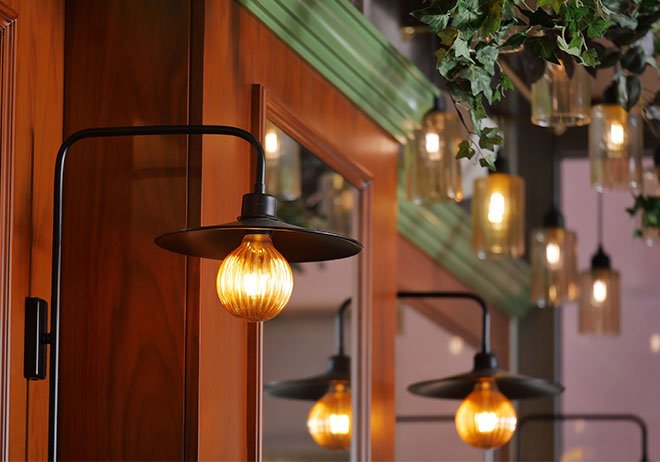 warm cafe lighting with wood accents and hanging lamps, bucca mor interior atmosphere cornwall