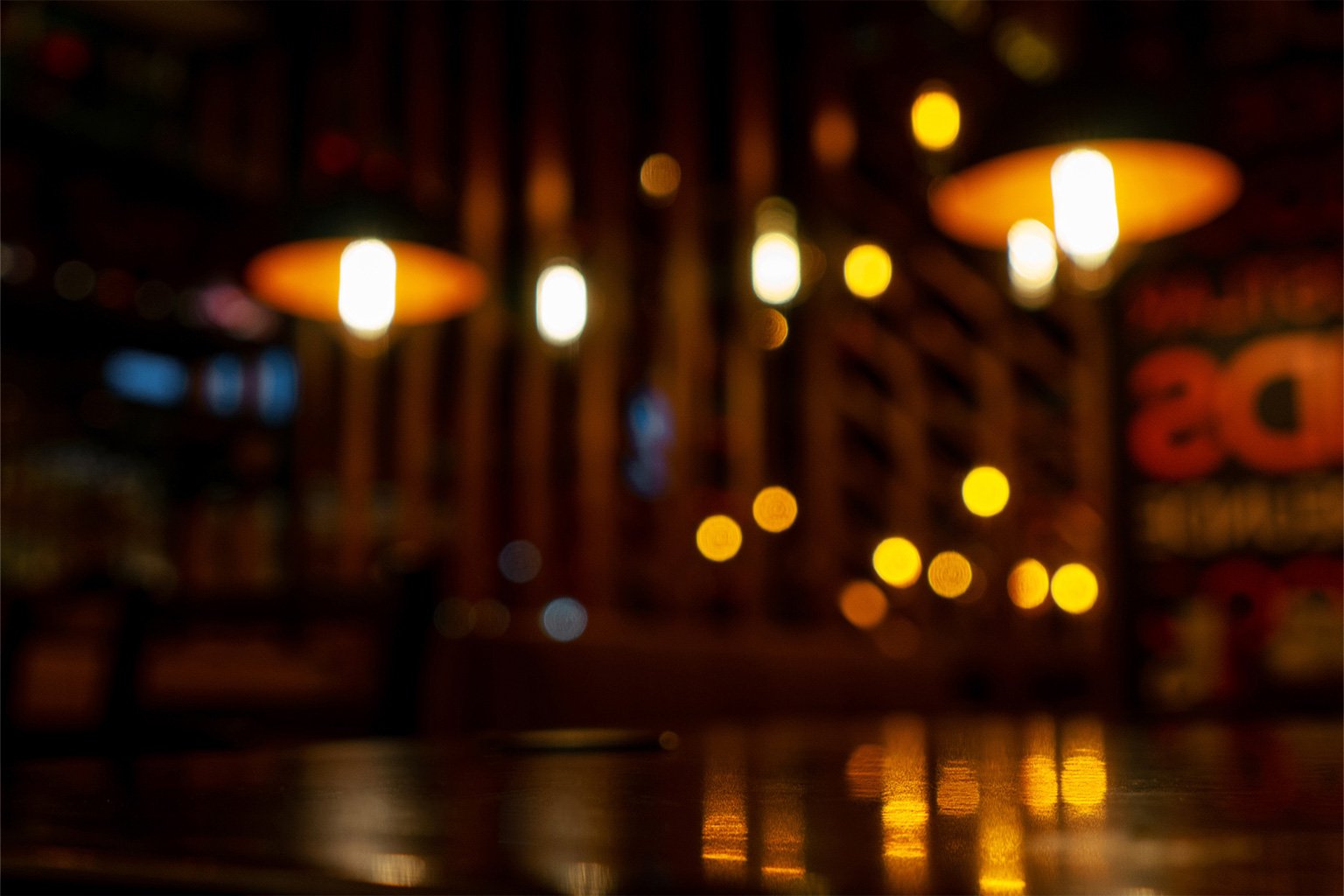 warm ambient lighting inside a freehouse pub creating a cosy atmosphere in Cornwall