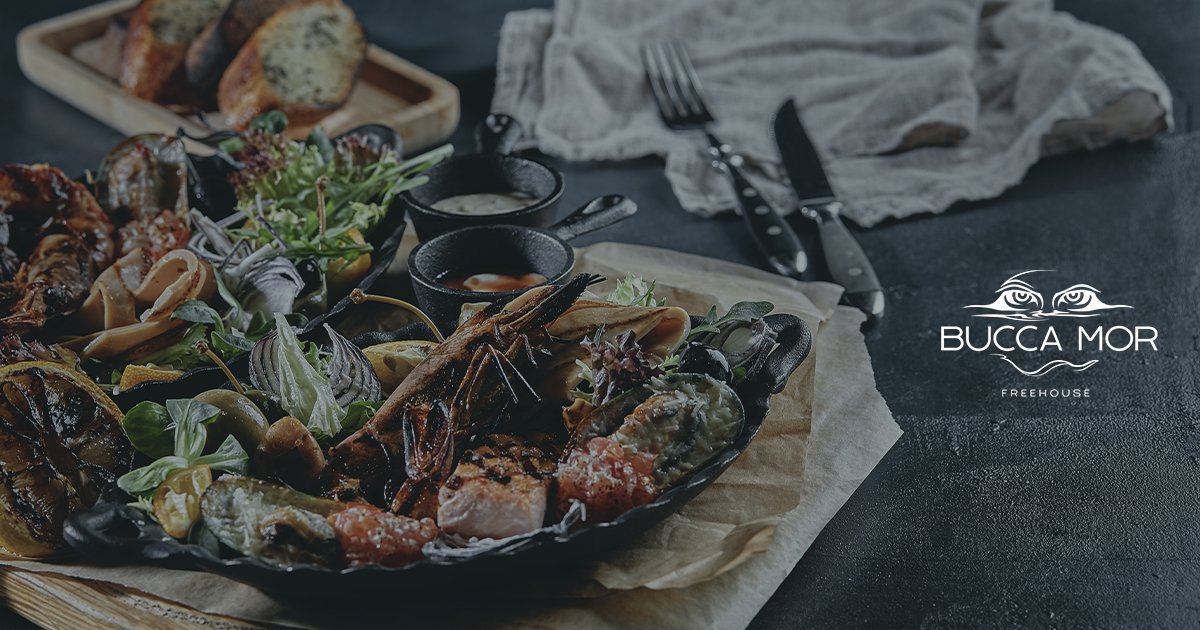 coastal seafood dish in a moody restaurant setting representing cornwall dining experience and bucca mor freehouse atmosphere