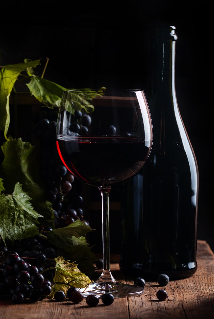 Glass of red wine beside a bottle in a gastro pub at BUCCA MOR Freehouse, Cornwall